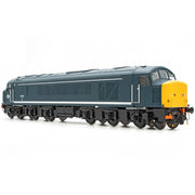 A detailed model train locomotive photographed on a seamless white studio background. The train features a dark slate blue body with a white stripe, black undercarriage and wheels, and a bright yellow front cab end.