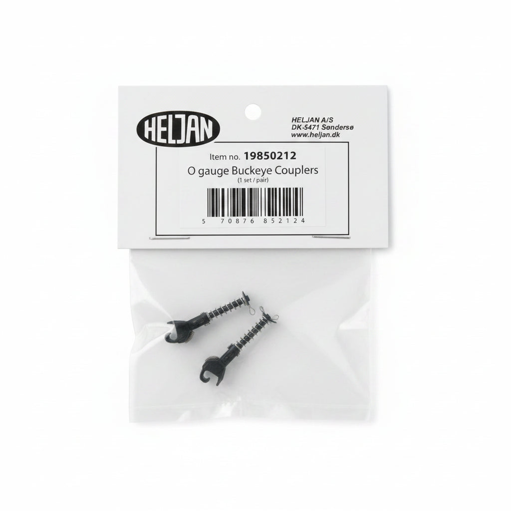 Two small black O gauge buckeye couplers in a clear plastic bag below their original white cardboard packaging label by Heljan.